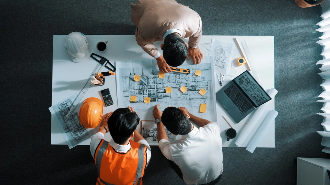 Architect reviewing custom home floor plans with homeowners